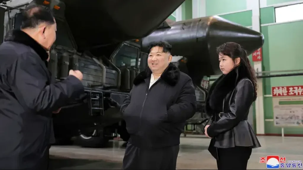 North Korean leader Kim Jong Un, center, with his daughter visits a factory that produces transport erector launchers in North Korea